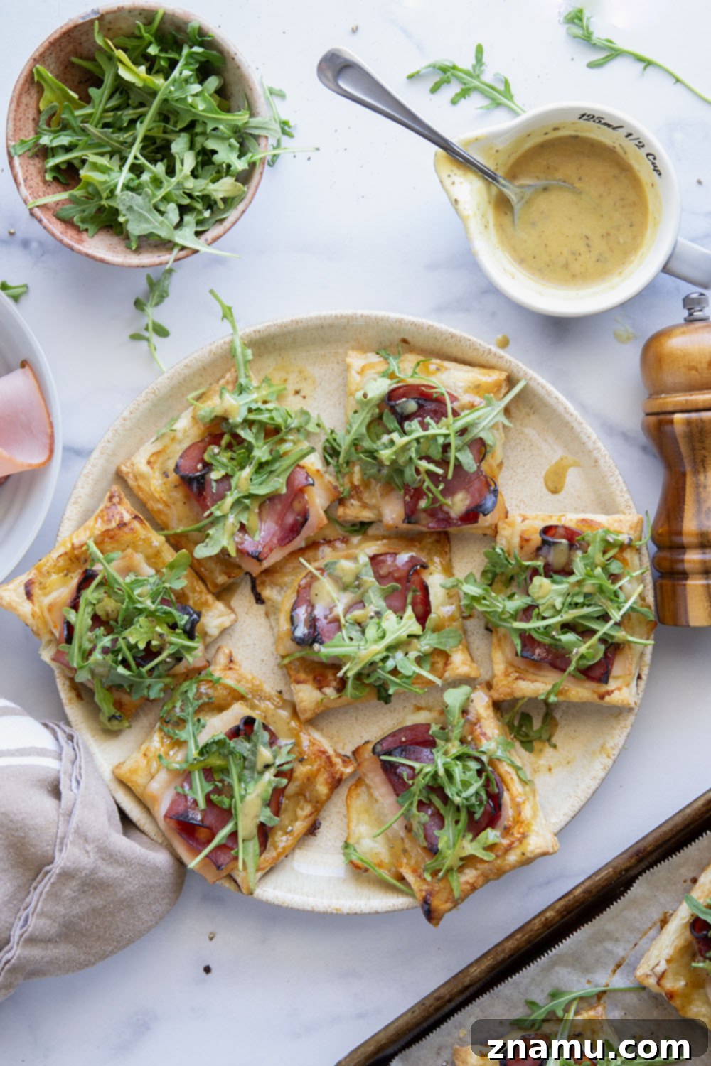 Flaky Chicken Cordon Bleu Tartlets 5 These savory cordon bleu puff pastry tarts have everything you'll find in the classic chicken dish in hand-held tart form! These tarts feature layers of deli ham, chicken, and Swiss cheese slices with a tangy honey mustard and lots of arugula piled on top.