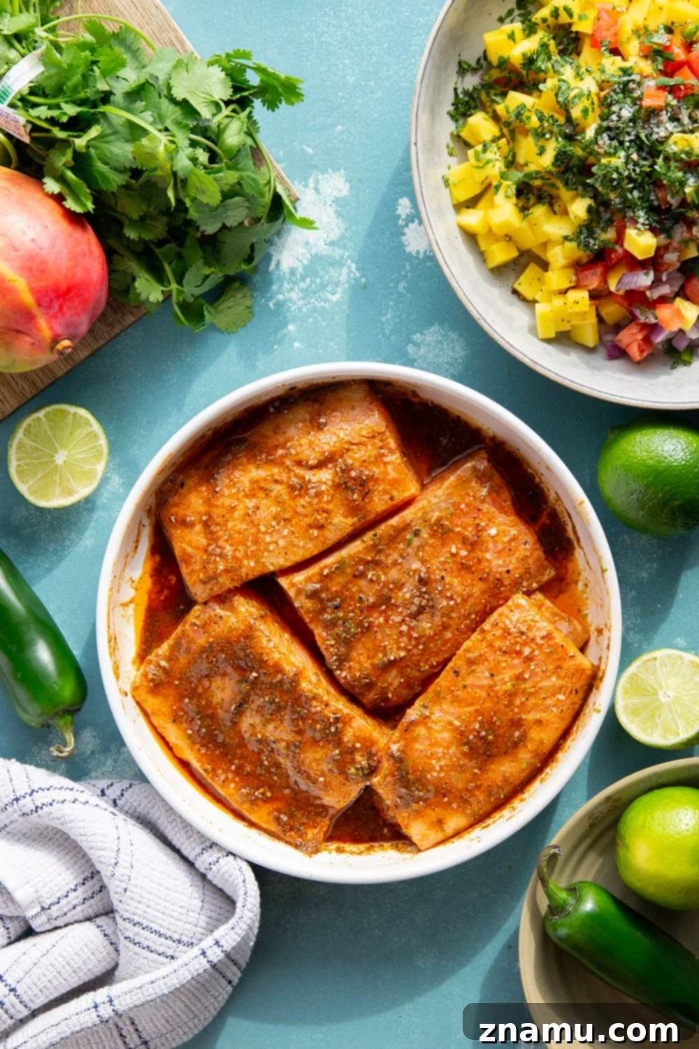 Marinated in a fresh lime and chili sauce, grilled to perfection, and topped with a super fresh mango salsa, this grilled chili lime salmon is an easy dinner that's full of flavor!