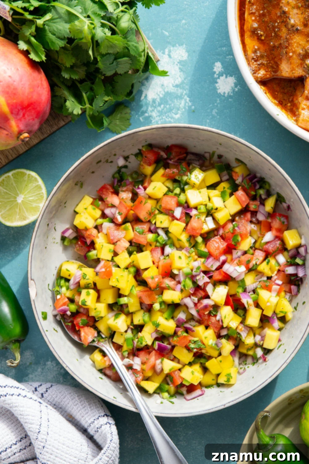 Marinated in a fresh lime and chili sauce, grilled to perfection, and topped with a super fresh mango salsa, this grilled chili lime salmon is an easy dinner that's full of flavor!