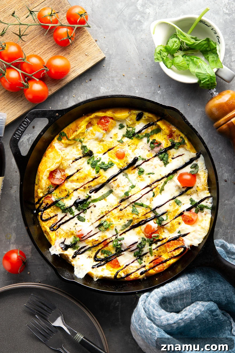 Caprese Frittata Recipe with Fresh Tomatoes, Basil & Mozzarella 4 Baked caprese frittata topped with basil and balsamic glaze.