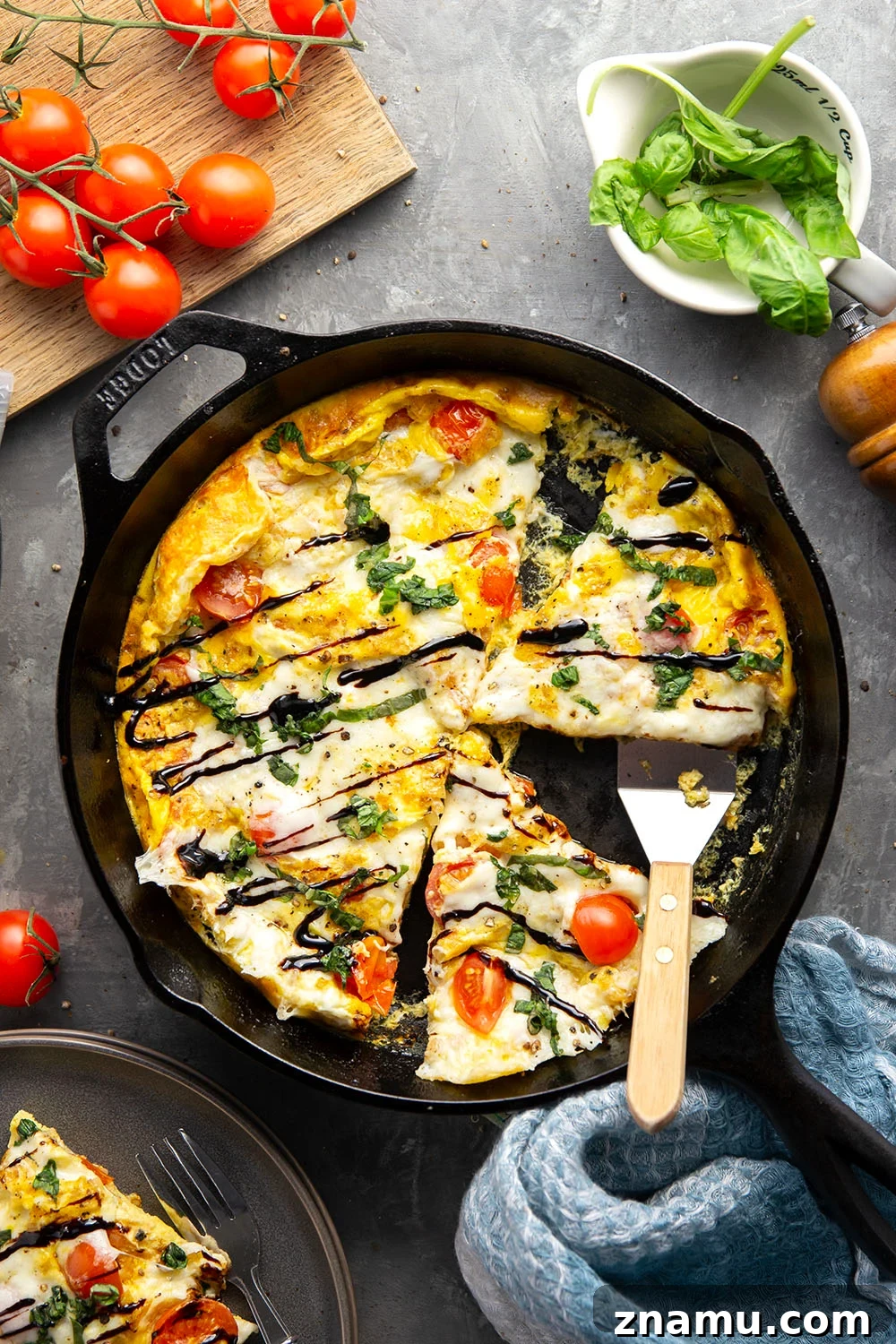 Caprese Frittata Recipe with Fresh Tomatoes, Basil & Mozzarella 6 A wedge of caprese frittata with basil and balsamic glaze.
