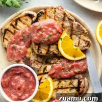 These grilled orange pork chops feature pork chops marinated in a fresh orange marinade, grilled until perfectly juicy, and served with a sweet and tangy rhubarb compote.