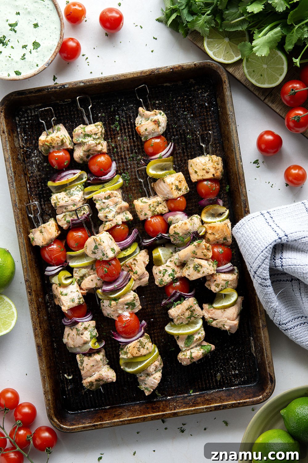 Cilantro-Lime Grilled Salmon Skewers for Summer BBQs 5 Marinated in a fresh cilantro lime sauce and grilled alongside red onion, cherry tomatoes, and served with a cilantro lime crema, these cilantro lime grilled salmon kabobs are a quick dinner to throw on the grill for any occasion.