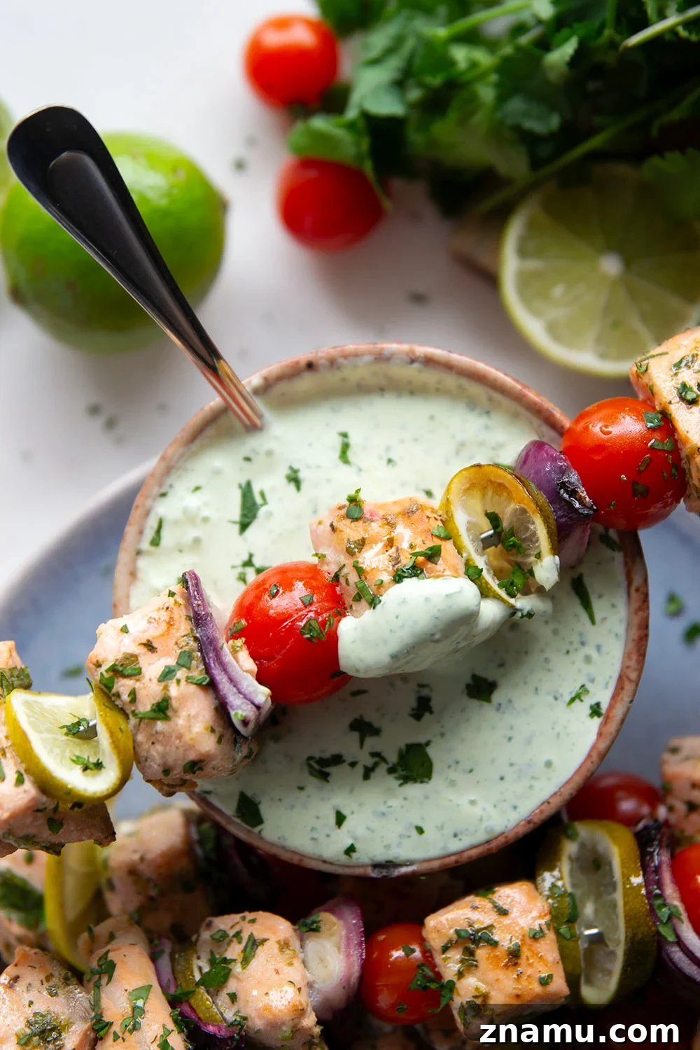 Cilantro-Lime Grilled Salmon Skewers for Summer BBQs 6 Marinated in a fresh cilantro lime sauce and grilled alongside red onion, cherry tomatoes, and served with a cilantro lime crema, these cilantro lime grilled salmon kabobs are a quick dinner to throw on the grill for any occasion.