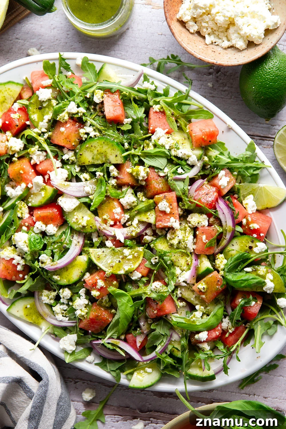 Sweet watermelon, tangy feta, and crisp cucumbers are the best salad combo in this watermelon feta cucumber salad that gets dressed in a fresh basil lime dressing and goes well with any summer meal.