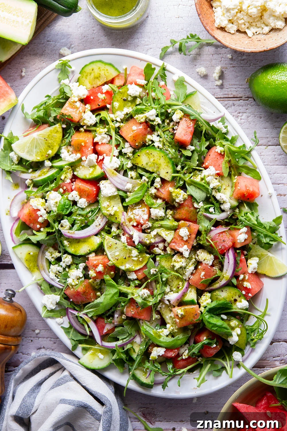 Sweet watermelon, tangy feta, and crisp cucumbers are the best salad combo in this watermelon feta cucumber salad that gets dressed in a fresh basil lime dressing and goes well with any summer meal.