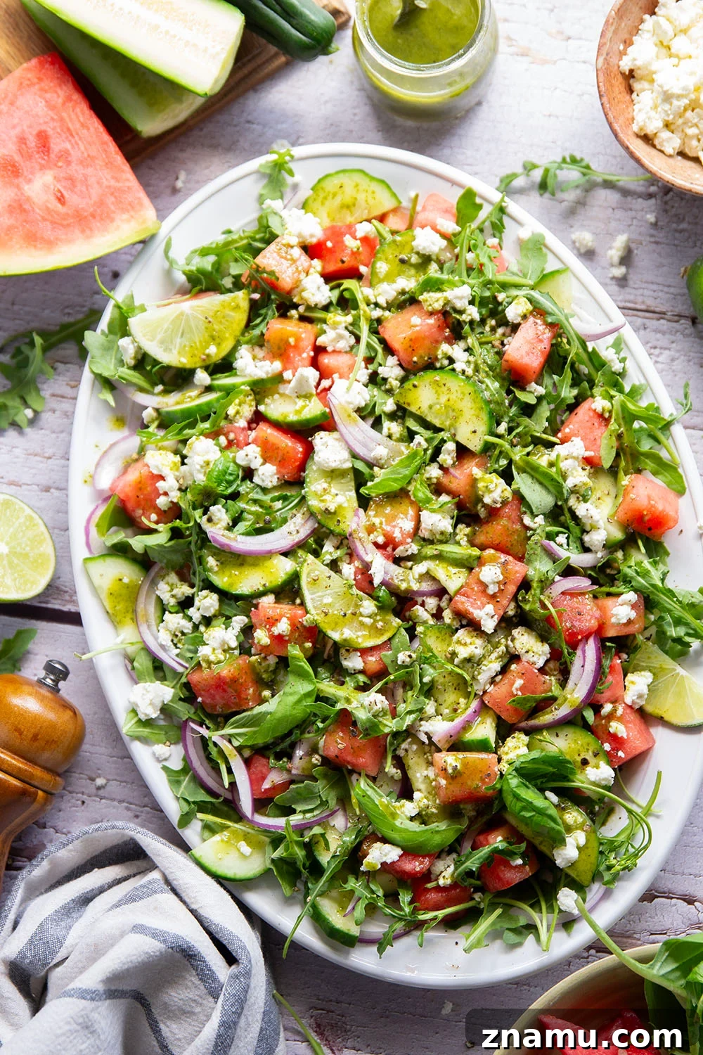 Sweet watermelon, tangy feta, and crisp cucumbers are the best salad combo in this watermelon feta cucumber salad that gets dressed in a fresh basil lime dressing and goes well with any summer meal.