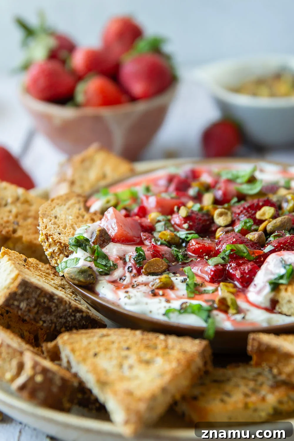 Whipped Goat Cheese with Honey-Roasted Strawberries Recipe 5 Silky whipped goat cheese is topped with juicy honey roasted strawberries and incredible served with crostini for dipping.