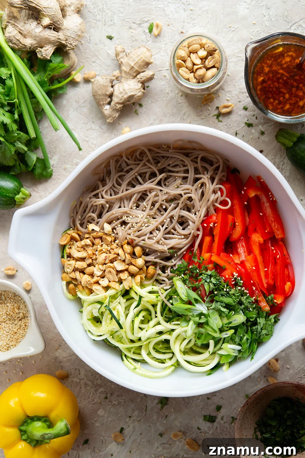 Zucchini Soba Salad with Sesame-Ginger Dressing 3 Zucchini and soba noodles are the perfect salad base in this zucchini soba noodle salad that features crunchy sweet peppers, lots of fresh herbs, and a flavorful fresh ginger sesame dressing.