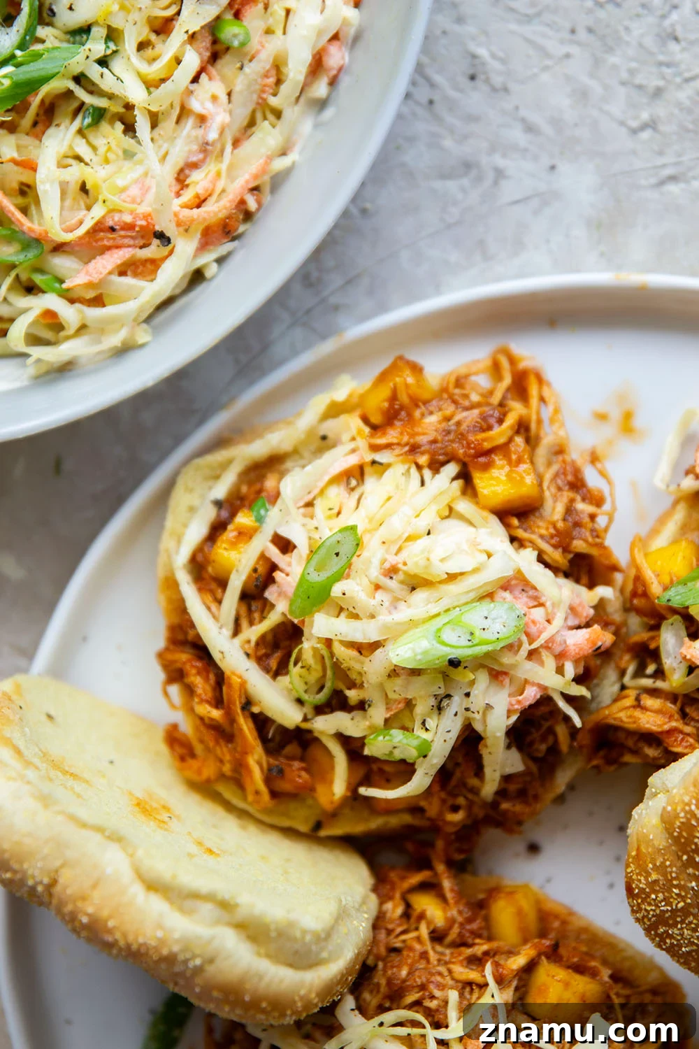 Pulled Mango BBQ Chicken Sandwich with Tangy Slaw 3 Shredded mango BBQ chicken ready for sandwiches.
