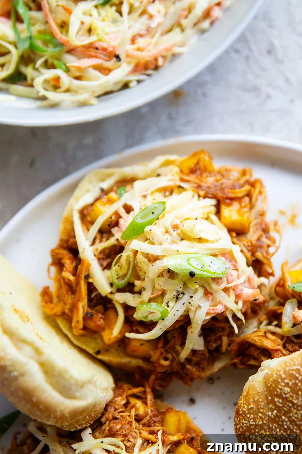 Pulled Mango BBQ Chicken Sandwich with Tangy Slaw 5 Slow cooker filled with mango BBQ chicken.