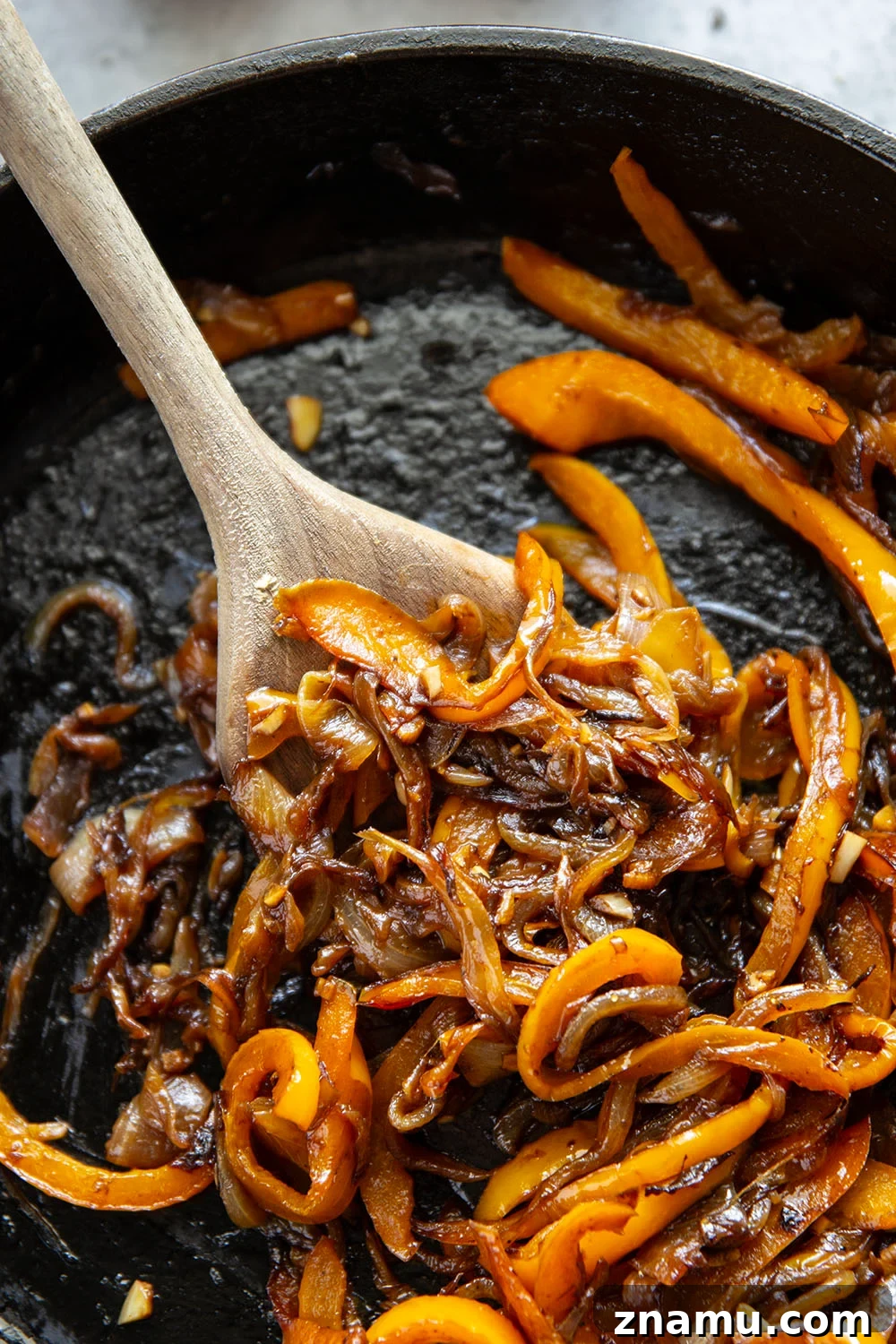 Juicy Burger with Caramelized Onions and Sweet Peppers 3 This juicy caramelized onion burger features caramelized onions and sweet peppers packed both inside the burger for extra flavor and more piled on top with a slice of pepperjack cheese and crisp lettuce.