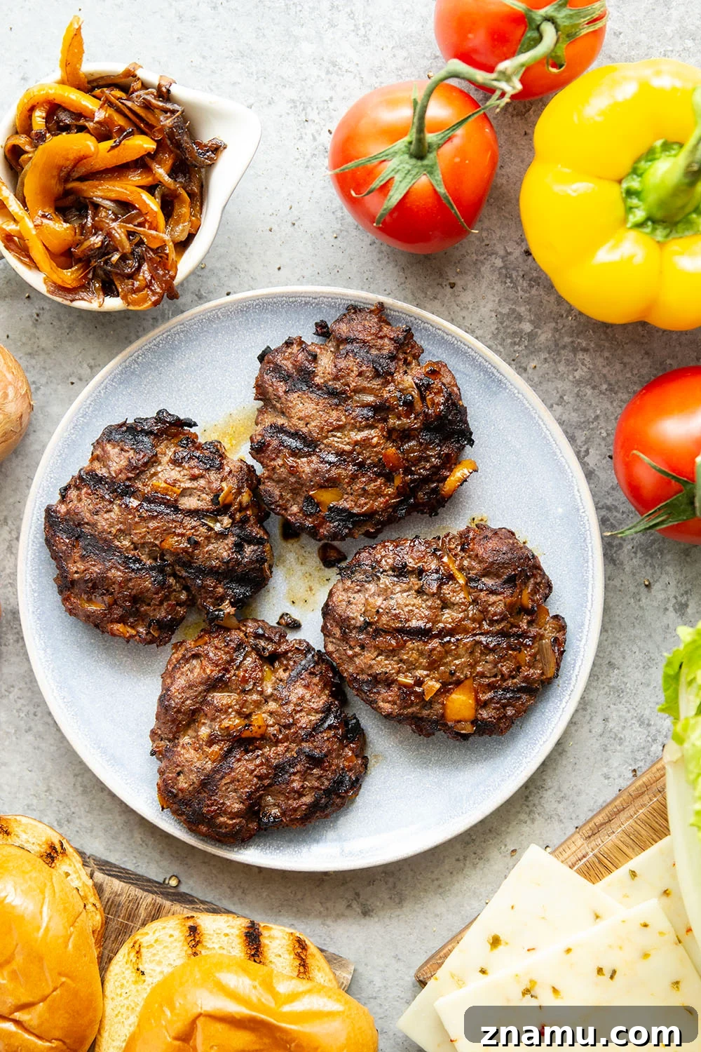 Juicy Burger with Caramelized Onions and Sweet Peppers 4 This juicy caramelized onion burger features caramelized onions and sweet peppers packed both inside the burger for extra flavor and more piled on top with a slice of pepperjack cheese and crisp lettuce.
