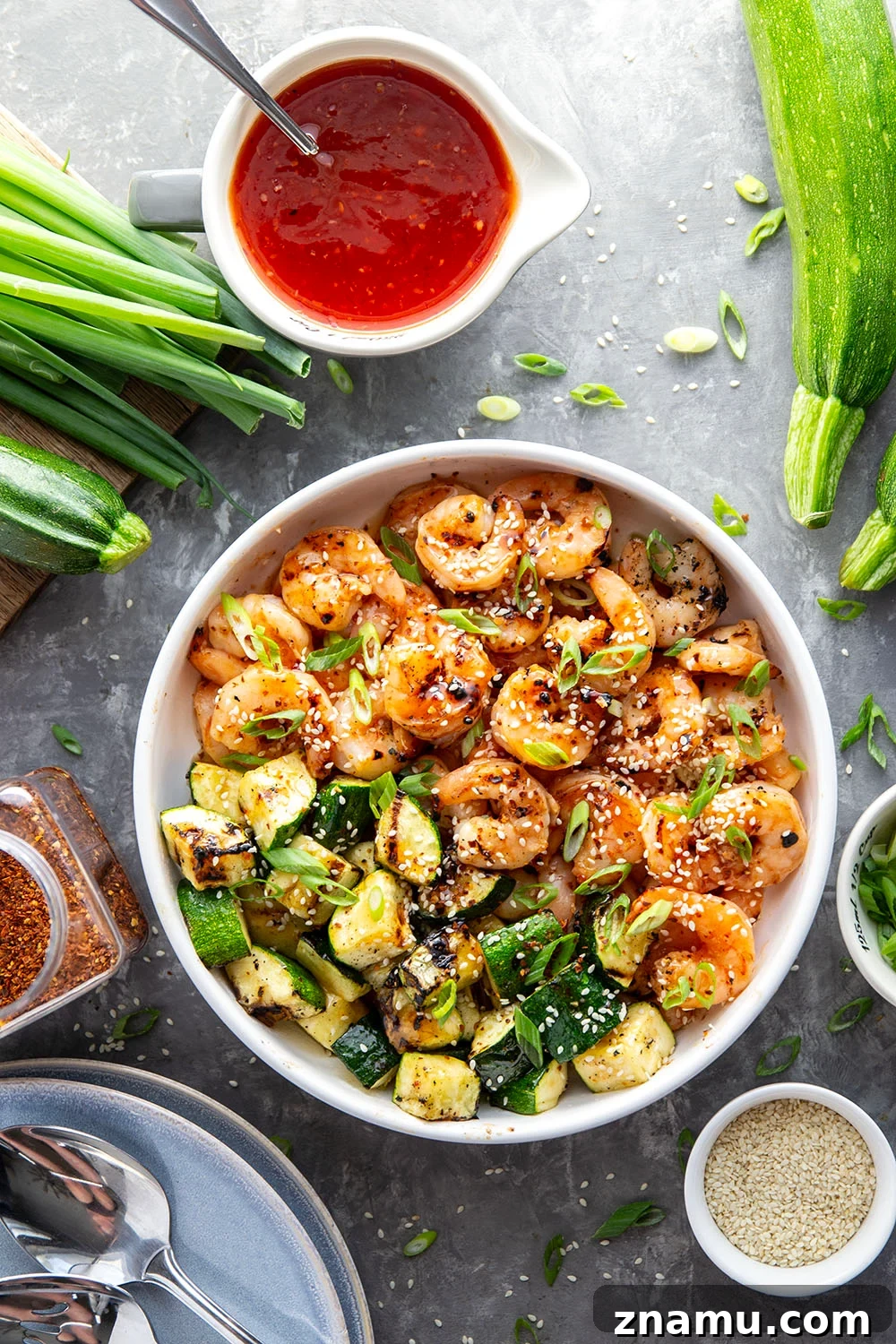 Grilled in spicy sweet chili sauce alongside tender zucchini cubes, this grilled sweet chili shrimp is a quick summer meal that's fantastic as an appetizer or served alongside rice.