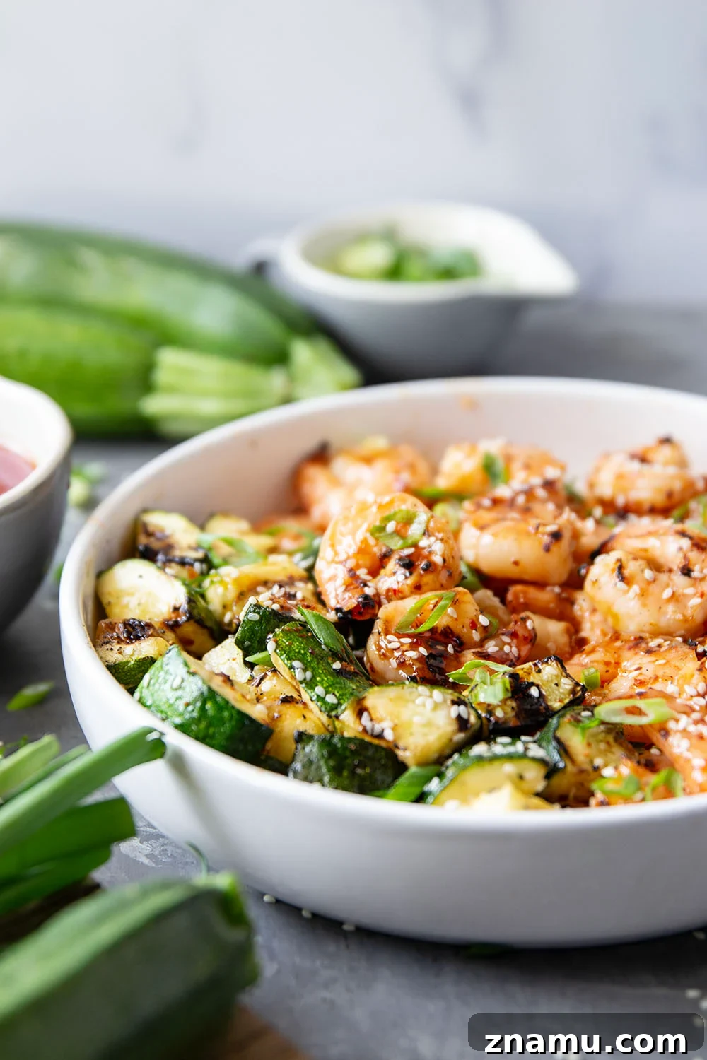 Grilled in spicy sweet chili sauce alongside tender zucchini cubes, this grilled sweet chili shrimp is a quick summer meal that's fantastic as an appetizer or served alongside rice.
