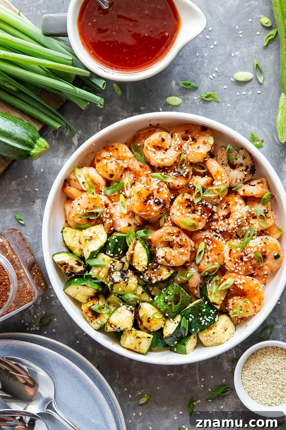 Grilled in spicy sweet chili sauce alongside tender zucchini cubes, this grilled sweet chili shrimp is a quick summer meal that's fantastic as an appetizer or served alongside rice.