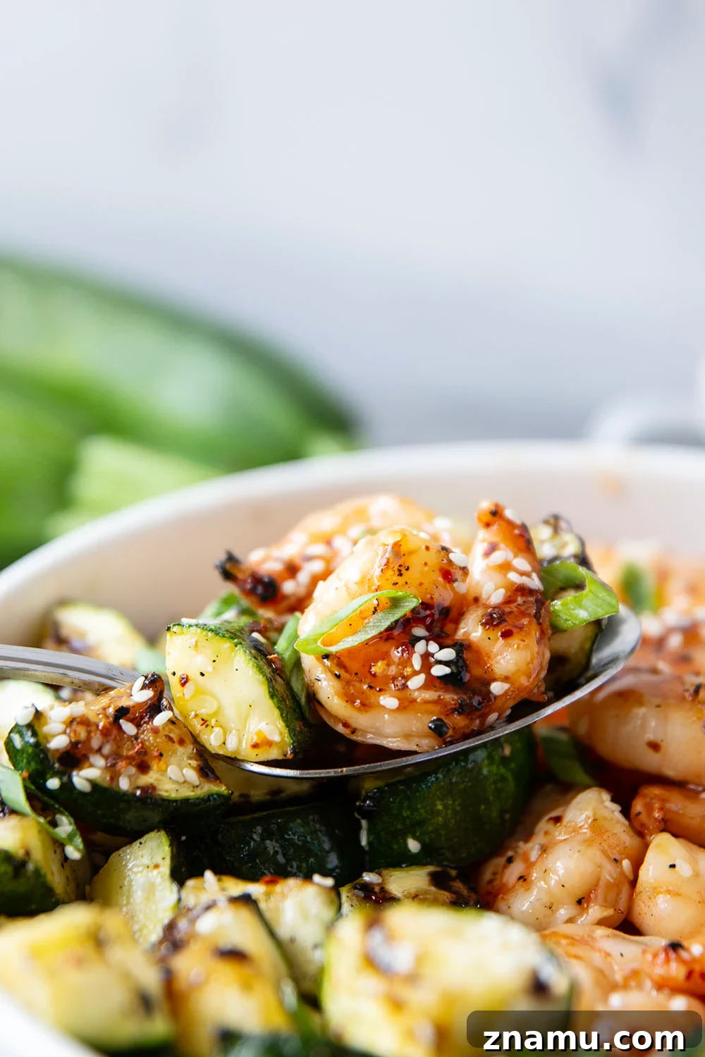 Grilled in spicy sweet chili sauce alongside tender zucchini cubes, this grilled sweet chili shrimp is a quick summer meal that's fantastic as an appetizer or served alongside rice.