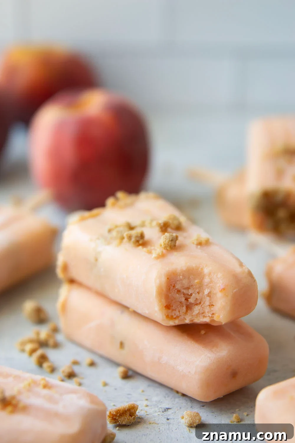 Peach popsicles stacked in freezer