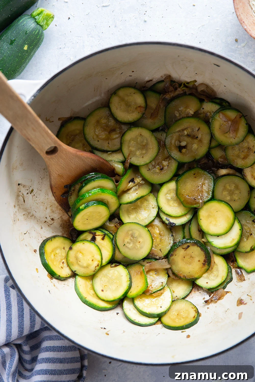 Creamy zucchini sauce with basil and Parmesan coating pasta.